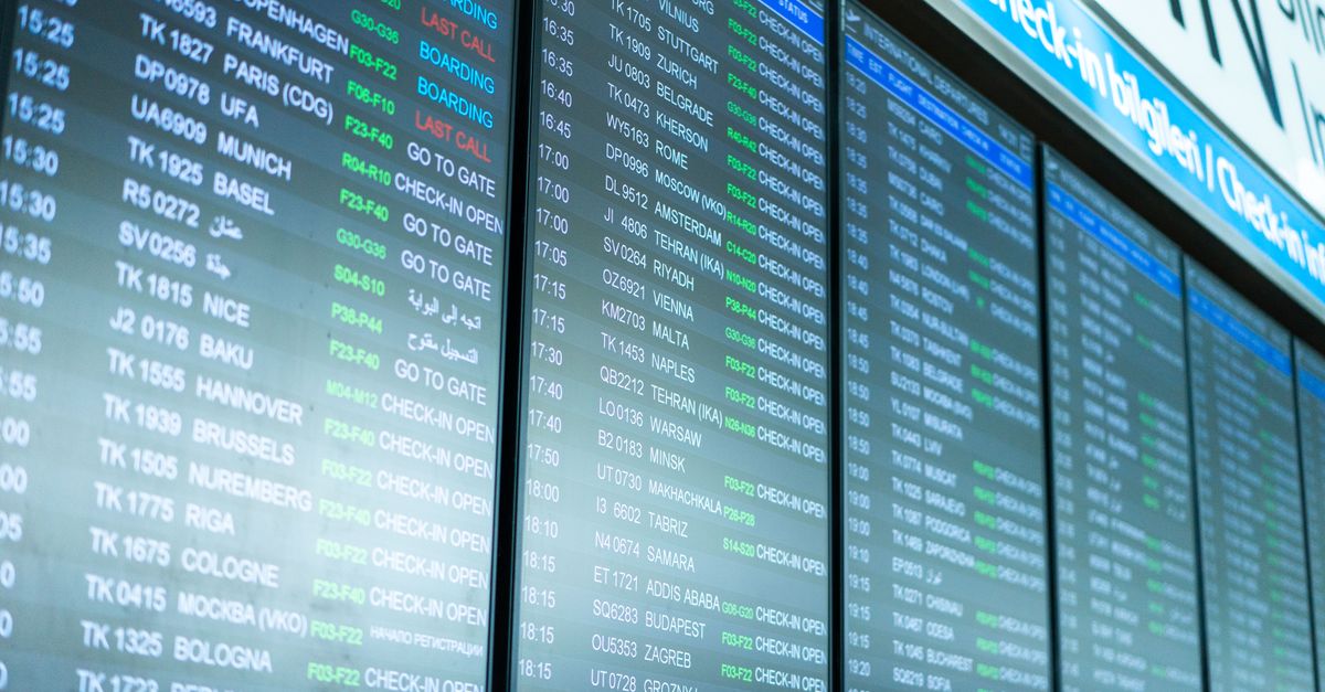 **SUBJECT:** A large airport departure board, showing flight information for multiple destinations.