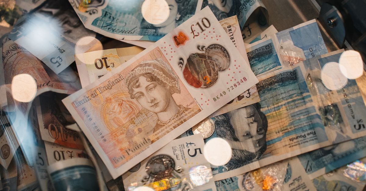 Close-up of UK Bank of England five and ten pound banknotes and a coin.