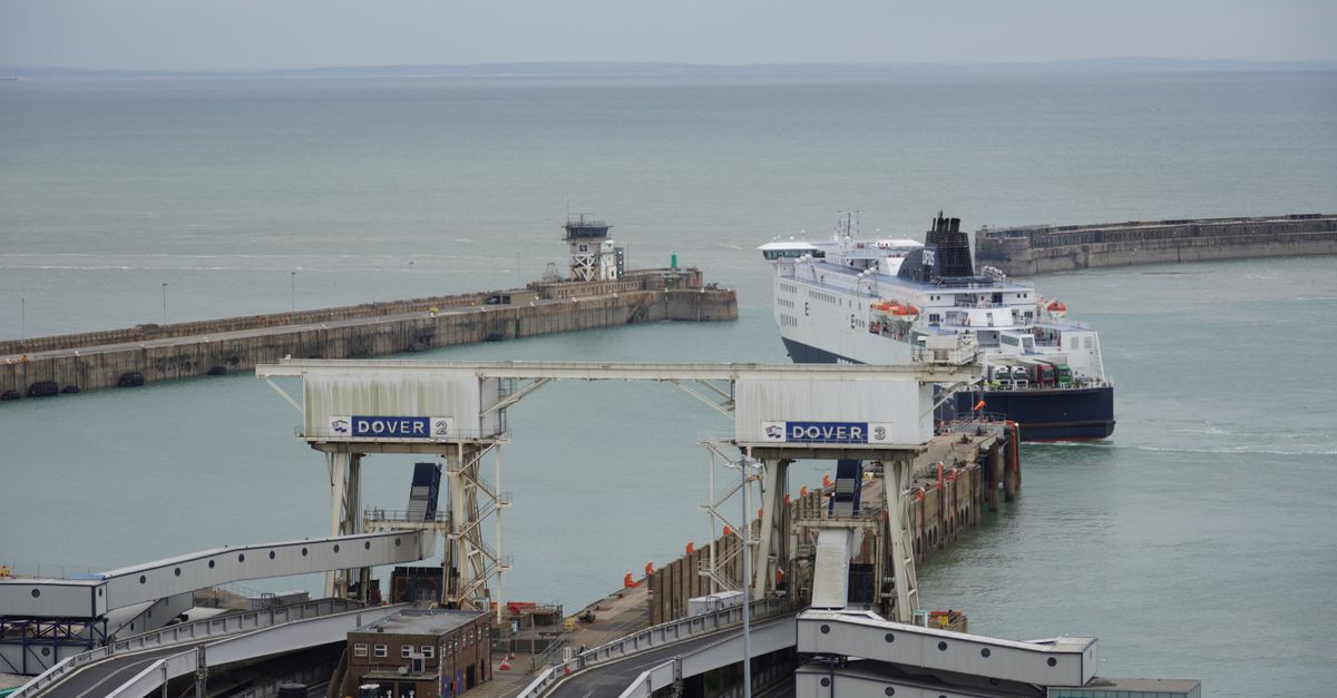 Ferry departing from the iconic Port of Dover on a cloudy day.