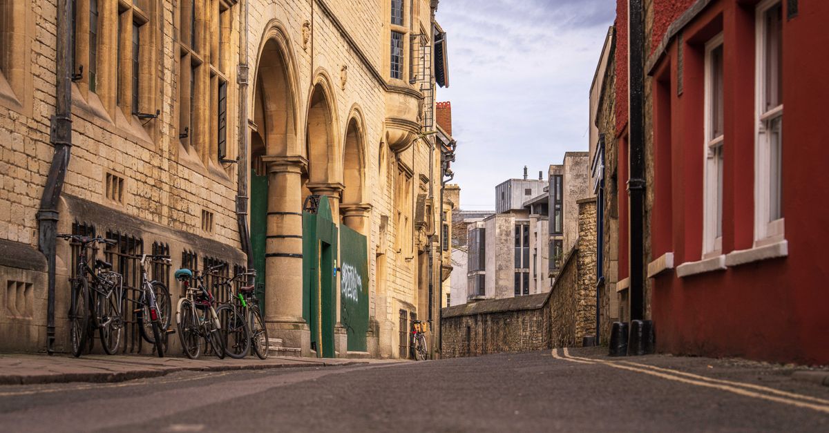 A picturesque cobblestone street in an old town with bicycles lined up against historical buildings.